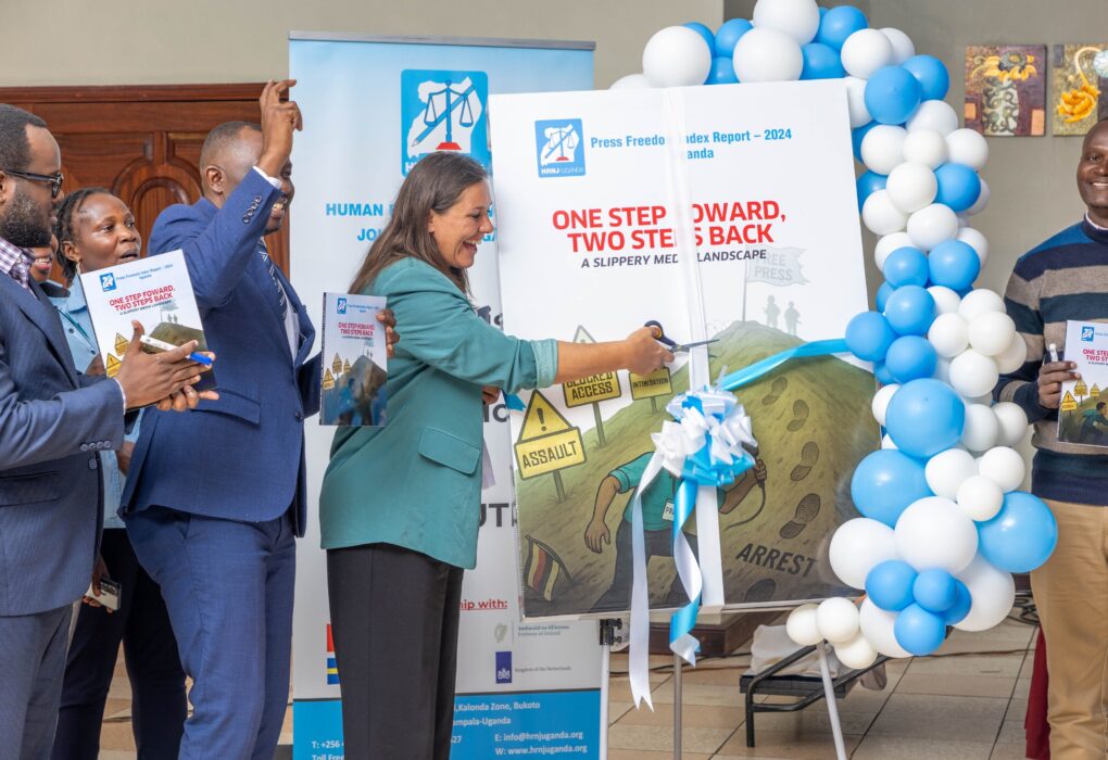 Kirstine Primdal Sutton of the Royal Danish Embassy signs a ceremonial copy of the Press Freedom Index Report 2024 Uganda at the HRNJ launch event.